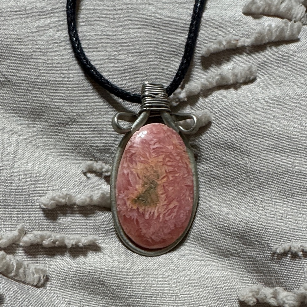 Stone pendant on black necklace